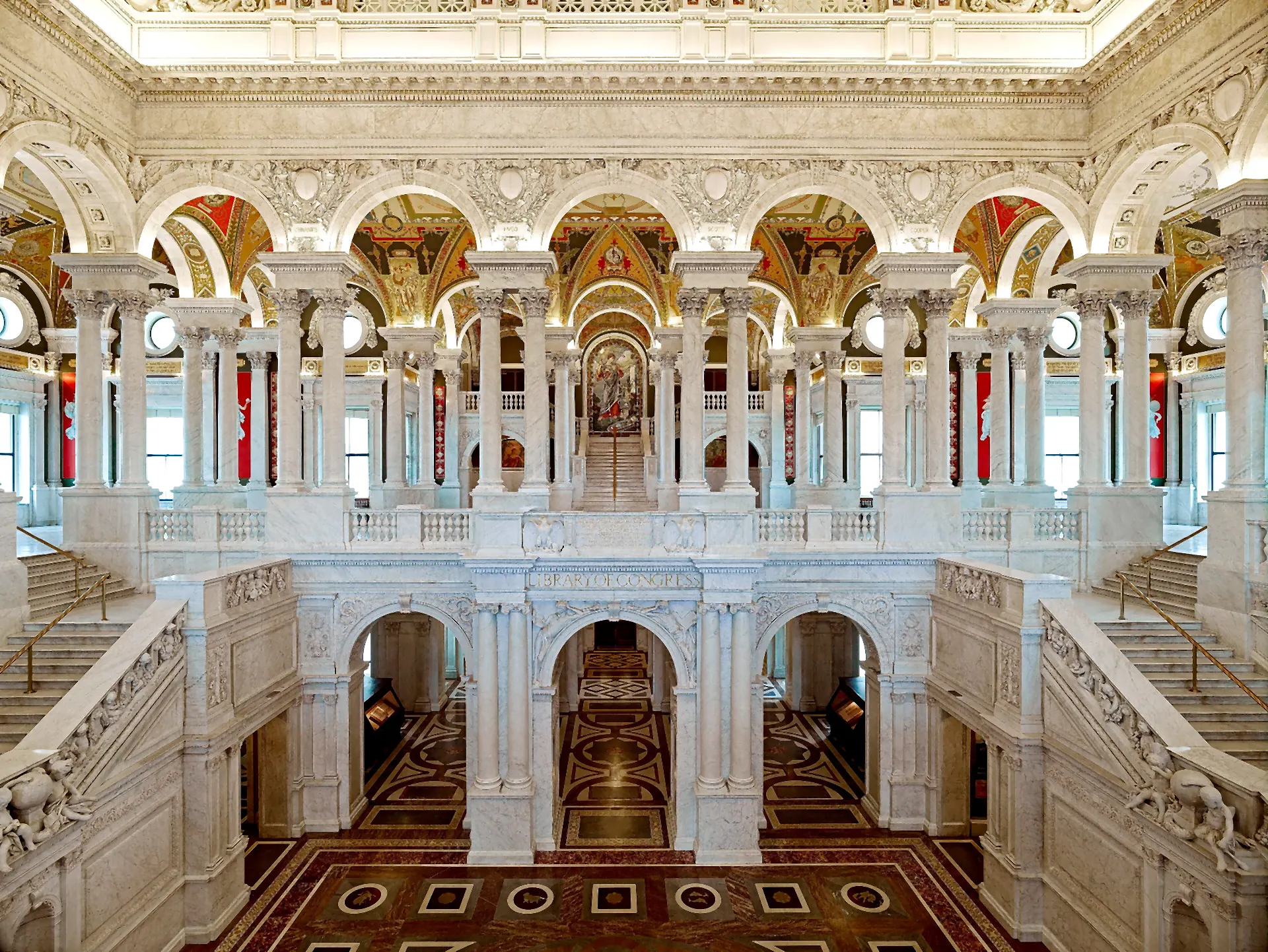 The Great Hall of the Thomas Jefferson Building — marble columns, mosaic floor and a vaulted, painted ceiling.